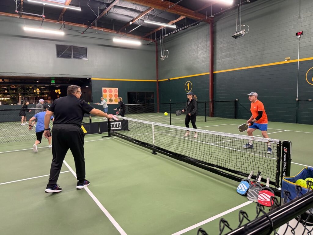 Pickleball players practising drills with a coach